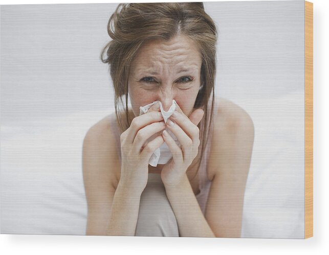 Cold And Flu Wood Print featuring the photograph Sick woman in bed blowing nose by Tom Merton