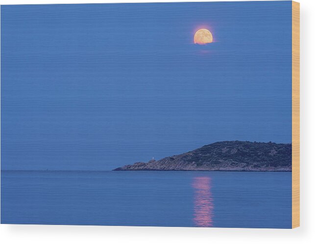 Moon Wood Print featuring the photograph Supermoon rising behind clouds above the sea by Alexios Ntounas