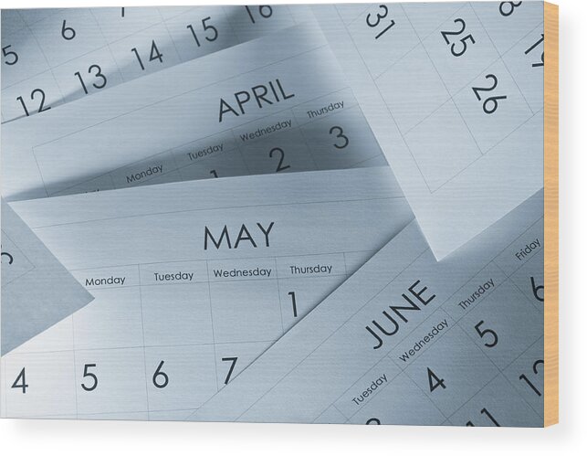 Calendar Date Wood Print featuring the photograph The months and days of the year on calendar paper by JLGutierrez