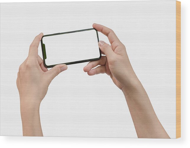 Empty Wood Print featuring the photograph Two hands holding big screen smart phone by Issarawat Tattong