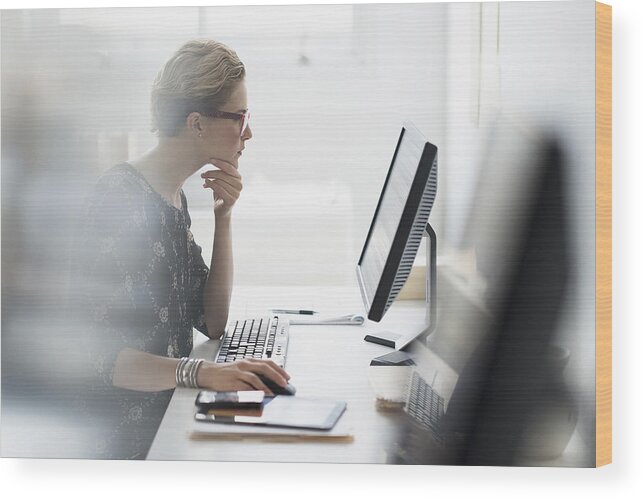 People Wood Print featuring the photograph USA, New Jersey, Side view of business woman working on desktop pc in office by Tetra Images