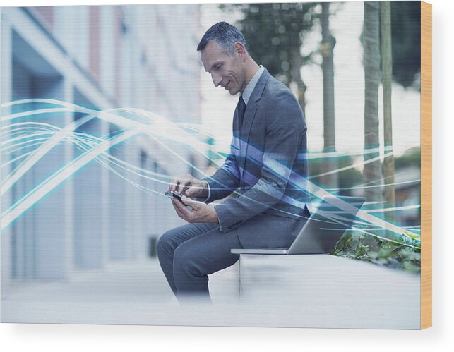 Corporate Business Wood Print featuring the photograph Waves of blue light and businessman texting on smartphone by Innocenti