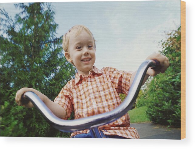 Part Of A Series Wood Print featuring the photograph Young Blond Boy Riding a Tricycle in a Park by Darryl Leniuk