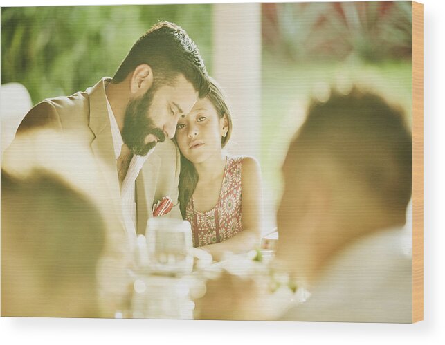 Mature Adult Wood Print featuring the photograph Young girl embracing father during outdoor wedding reception dinner by Thomas Barwick
