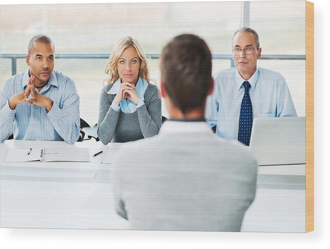 Working Wood Print featuring the photograph Young man have job interview. by Skynesher