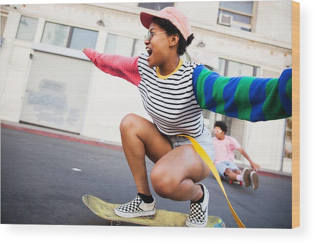 Baseball Cap Wood Print featuring the photograph Young woman skateboarding by Stephen Zeigler