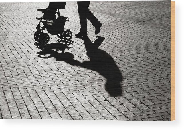Shadow Wood Print featuring the photograph Black And White Shadow Of Baby Carriage On Sidewalk Stones by Selimaksan