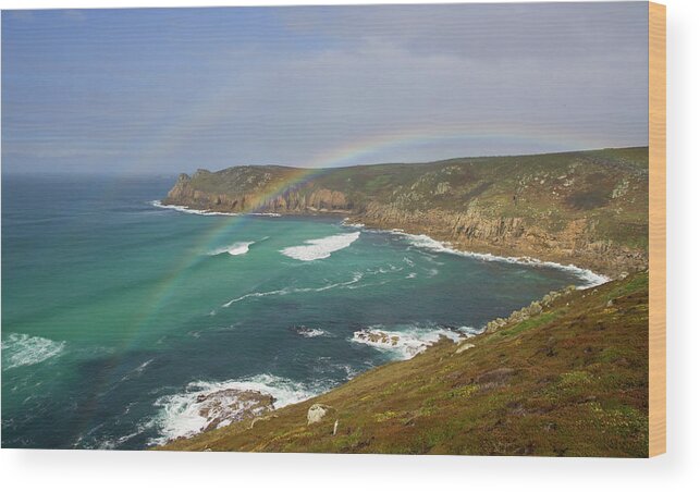 Nanjizal Cornwall Wood Print featuring the photograph Rainbow over Nanjizal Bay in Cornwall by Pete Hemington