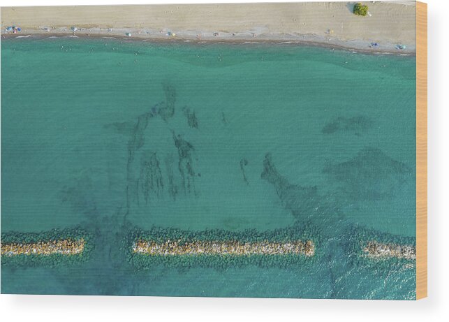 Beachfront Wood Print featuring the photograph Aerial view from flying drone of people relaxing on the beach. Paphos Cyprus by Michalakis Ppalis
