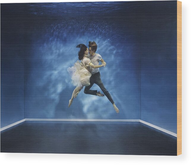 Tranquility Wood Print featuring the photograph A couple dancing under water by Henrik Sorensen