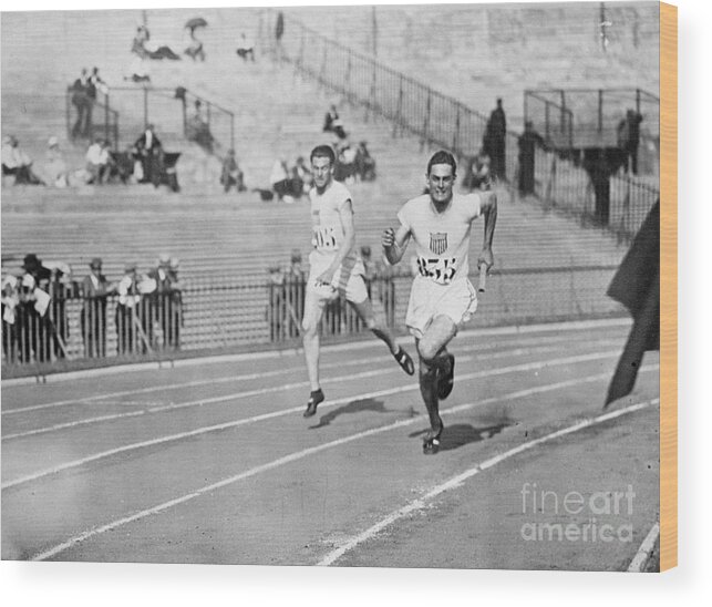 The Olympic Games Wood Print featuring the photograph Mens Olympic Relay Team In Action by Bettmann