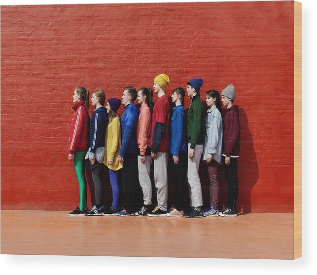 Young Men Wood Print featuring the photograph Young people standing against each other by Henrik Sorensen