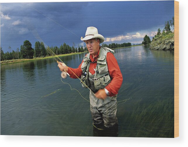 A Man In A Cowboy Hat Fly Fishing Wood Print