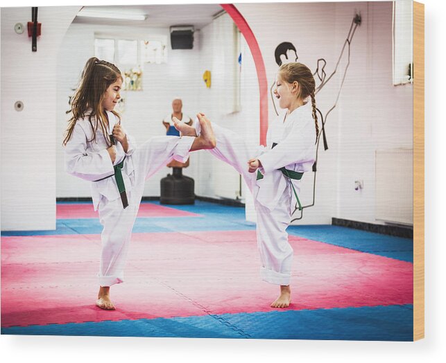 4-5 Years Wood Print featuring the photograph Cute girls on Taekwondo training by Drazen_