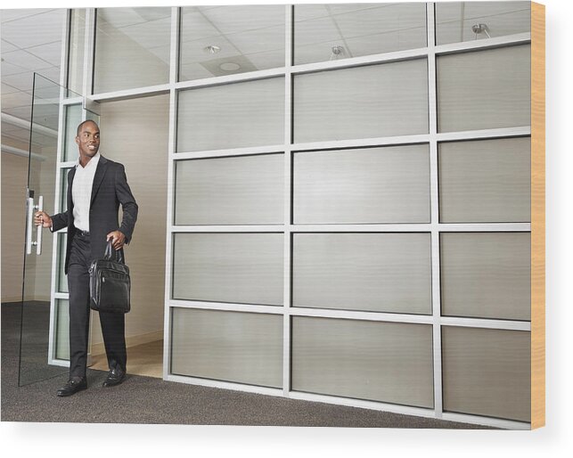 Young Men Wood Print featuring the photograph Mixed race businessman leaving modern office by Tanya Constantine