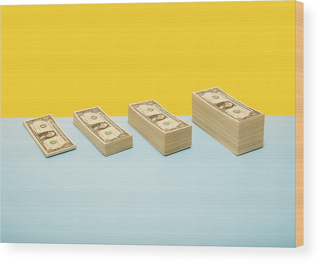 In A Row Wood Print featuring the photograph Stacks of US 1 dollar bills in ascending order by PM Images