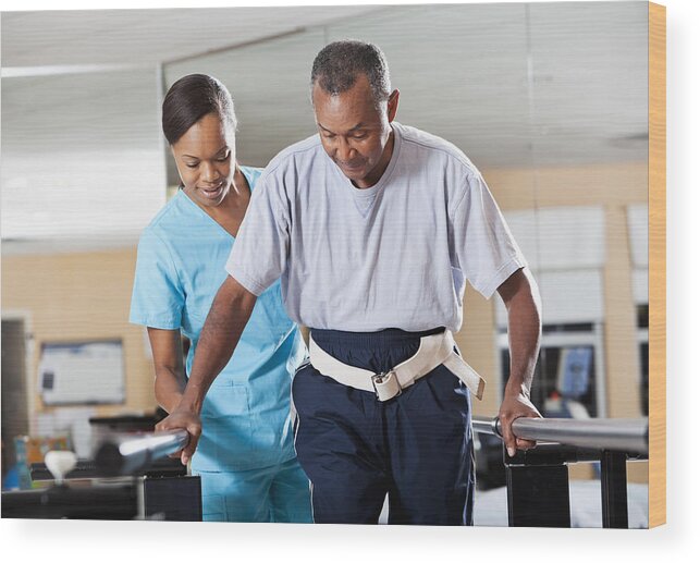 Expertise Wood Print featuring the photograph Therapist with patient doing gait training by Kali9