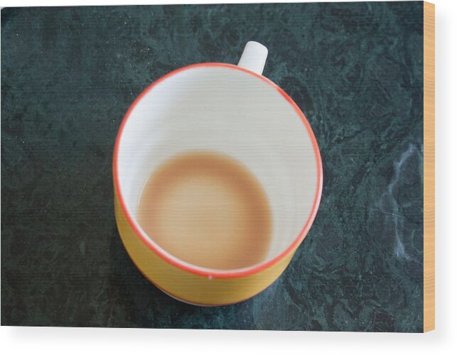 Cup Wood Print featuring the photograph A cup with the remains of tea on a green table by Ashish Agarwal