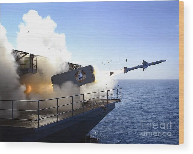 Uss Abraham Lincoln Wood Print featuring the photograph A Rim-7 Sea Sparrow Missile Launches by Stocktrek Images