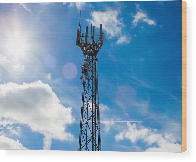 Aerial Wood Print featuring the photograph Mobile phone mast with a blue sky behind by Fizzy Image
