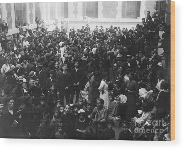Crowd Of People Wood Print featuring the photograph Crowd Of Immigrants Wait At Ellis Island by Bettmann