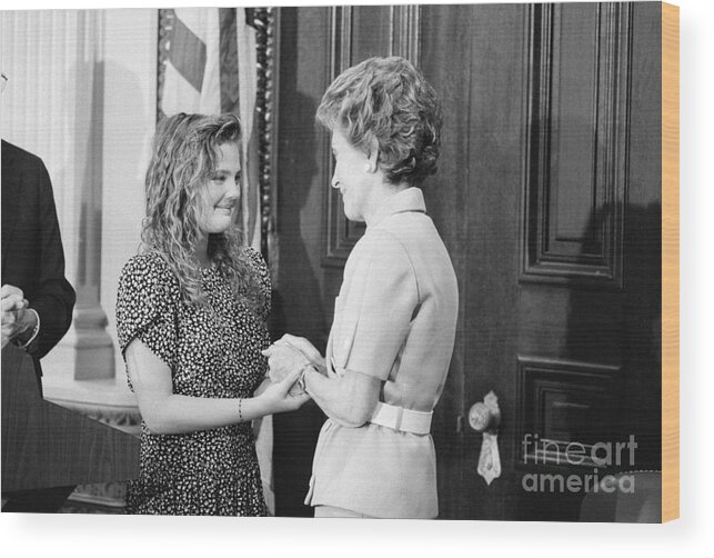 1980-1989 Wood Print featuring the photograph Drew Barrymore With Nancy Reagan by Bettmann