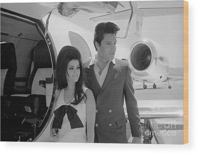 Following Wood Print featuring the photograph Elvis And Priscilla Presley Posing by Bettmann