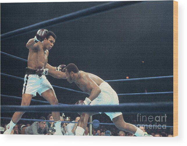 Joe Frazier Wood Print featuring the photograph Muhammad Ali Boxing Against Joe Frasier by Bettmann