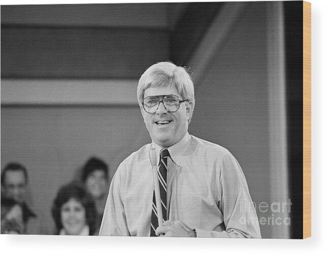 1980-1989 Wood Print featuring the photograph Phil Donahue Standing While Working by Bettmann