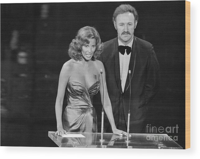 Gene Hackman Wood Print featuring the photograph Raquel Welch And Gene Hackman by Bettmann