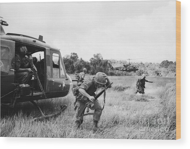 Vietnam War Wood Print featuring the photograph Soldiers Climbing Out Of Helicopter by Bettmann