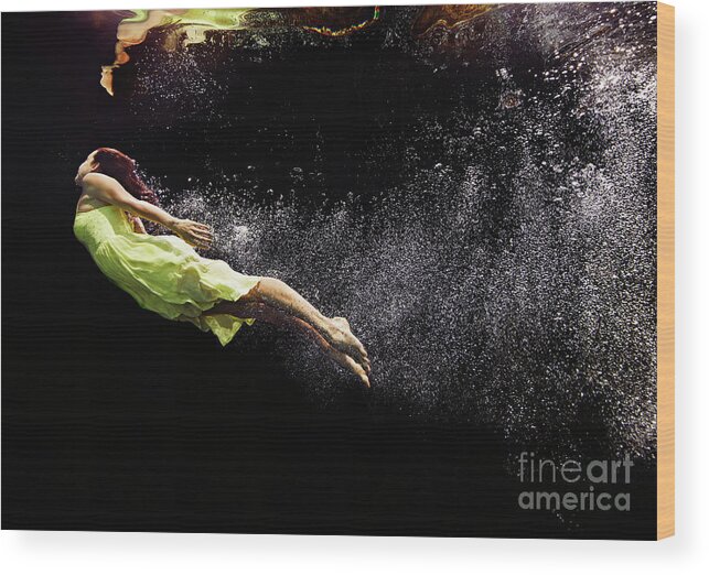 Tranquility Wood Print featuring the photograph Woman In Yellow Dress Swimming To Water by Thomas Barwick