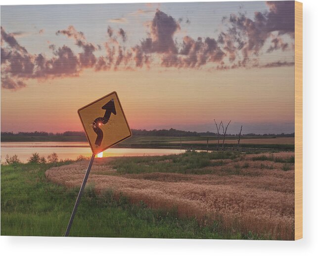 Sign Curve Scenic Landscape North Dakota Lake Syzygy Alignment Sun Pinhole Roadsign Hunting Bullet Humor Star Bullet Hole Shooting Shot Wood Print featuring the photograph Dodged a Bullet - curve in road sign with sunlight through bullet hole by Peter Herman