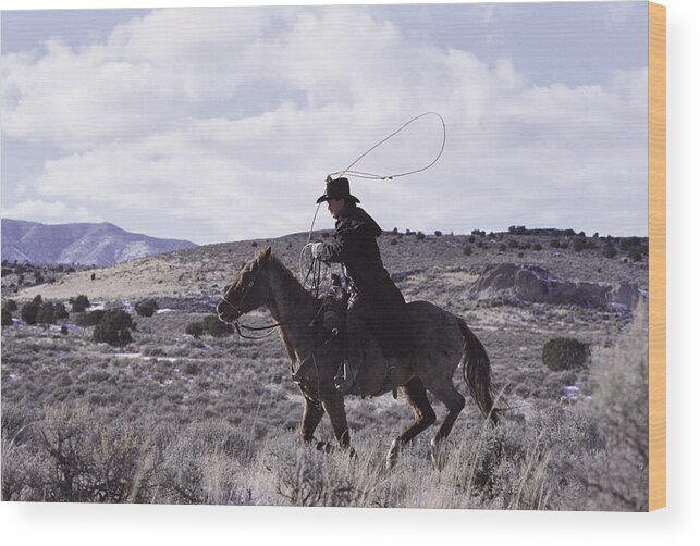 One Man Only Wood Print featuring the photograph A Cowboy Rides His Horse by Photodisc
