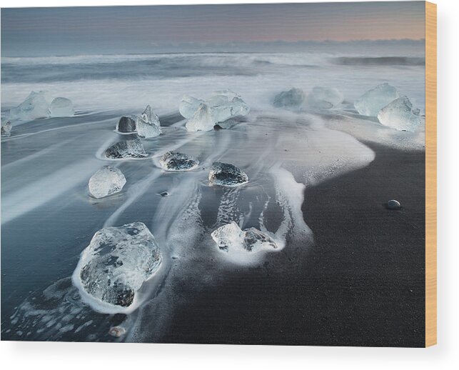 Scenics Wood Print featuring the photograph Icebergs on a beach at sunrise. by Alex Saberi