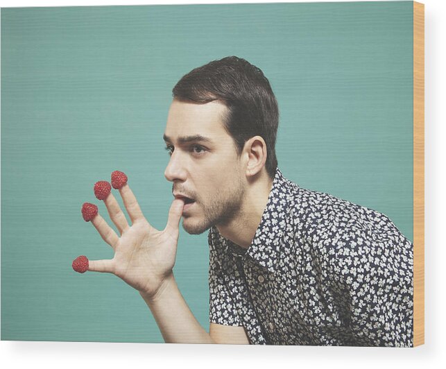 Diversity Wood Print featuring the photograph Man with raspberries on finger tips by Alma Haser