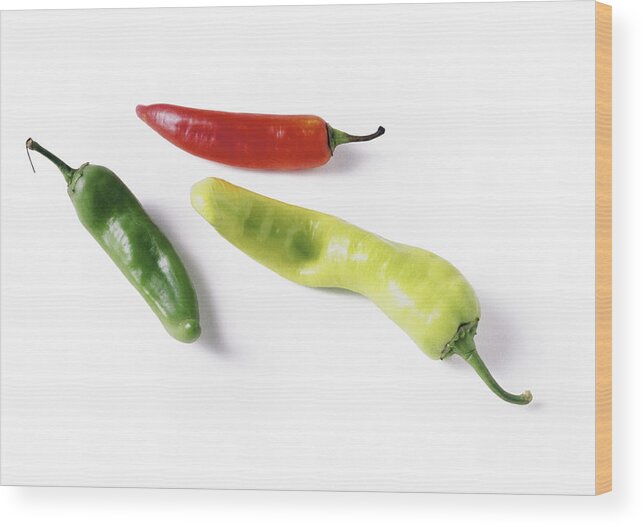 White Background Wood Print featuring the photograph Red and green chili peppers, full length by Isabelle Rozenbaum