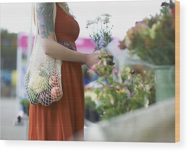 Hipster Culture Wood Print featuring the photograph Woman shopping on local market with plastic free reusable bag. by Dougal Waters