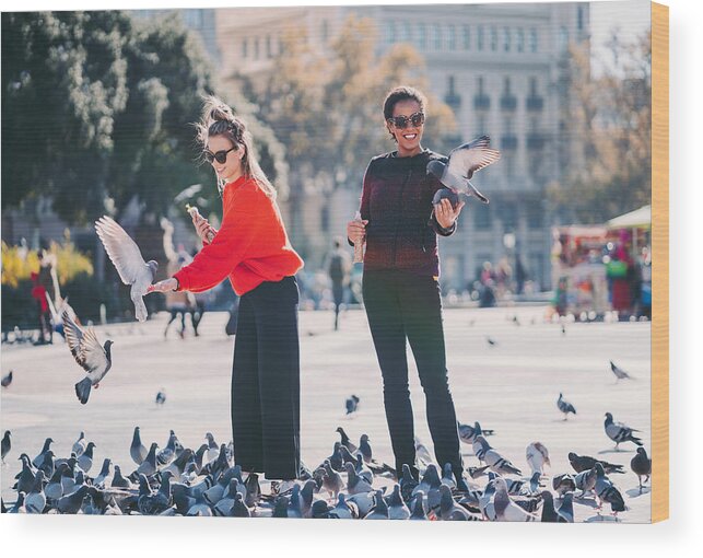White People Wood Print featuring the photograph Women traveling in Europe and feeding pigeons in Barcelona by Martin-dm