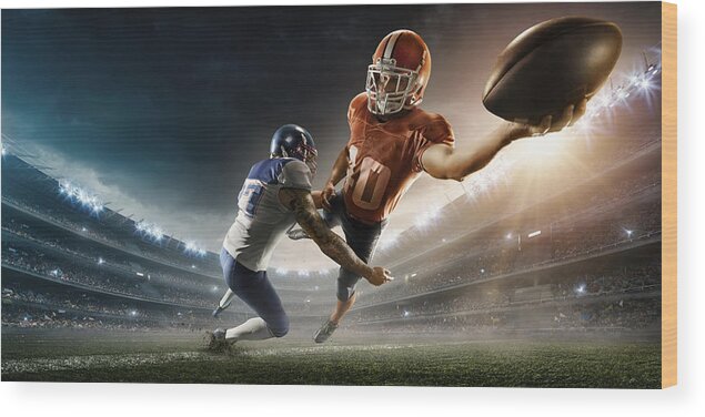 Event Wood Print featuring the photograph American football player being tackled #2 by Dmytro Aksonov