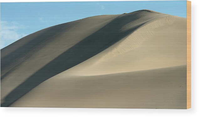 Shadow Wood Print featuring the photograph A Large Sand Dune Against A Blue Sky by Keith Levit / Design Pics