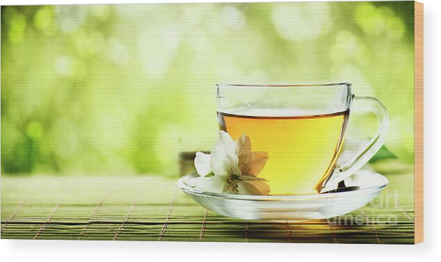 Tea Wood Print featuring the photograph Herbal cup of tea on wooden table by Jelena Jovanovic