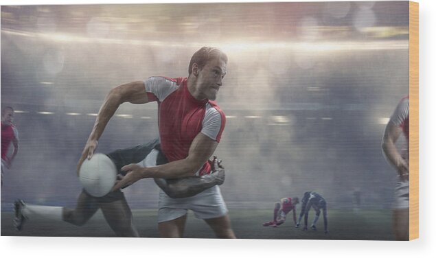 People Wood Print featuring the photograph Rugby Player About To Pass Whilst Being Tackled During Match by Peepo