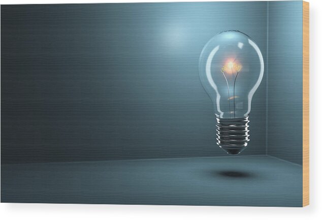 Mid-air Wood Print featuring the photograph Light Bulb Glowing by Jonathan Kitchen