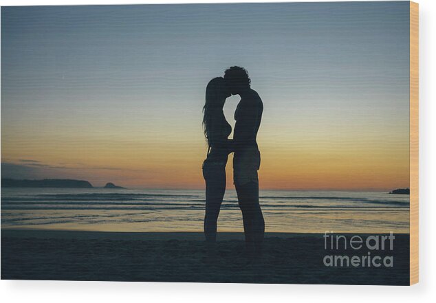 Young Men Wood Print featuring the photograph Young Couple Kissing On The Beach by Westend61