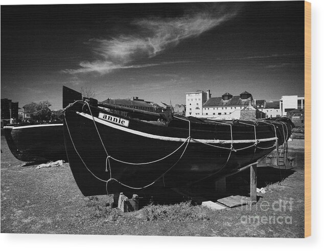 Galway Wood Print featuring the photograph old traditional boats tied up on shoreline on corrib river near harbour Galway by Joe Fox