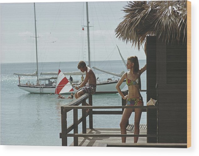 Beach Hut Wood Print featuring the photograph Fishing On Honeymoon Porch by Slim Aarons