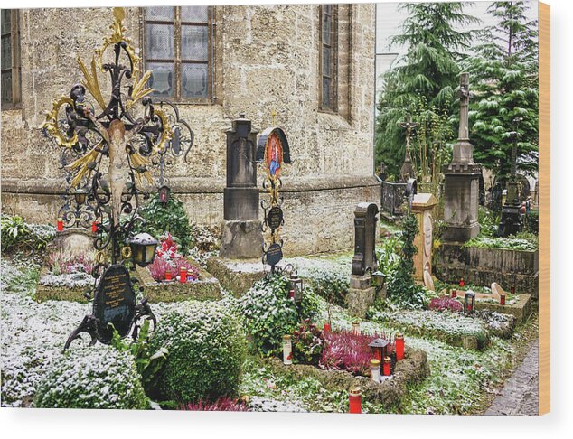 Snow On The Graves At Petersfriedhof Wood Print featuring the photograph Snow on the Graves at Petersfriedhof in Salzburg by John Rizzuto