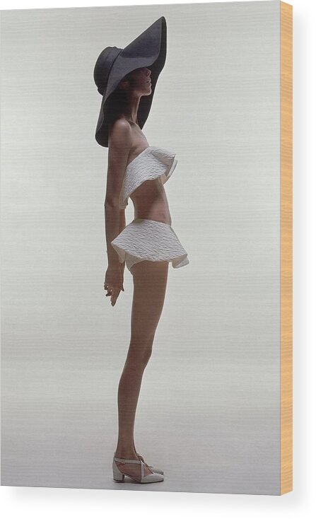 Fashion Wood Print featuring the photograph A Model Wearing A Two Piece Bathing Suit by Bert Stern