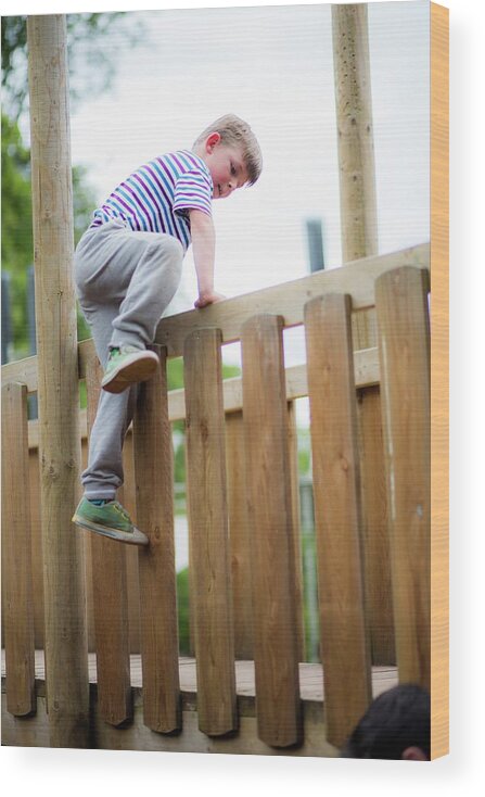 Photography Wood Print featuring the photograph Boy Climbing Over Wooden Fence by Samuel Ashfield